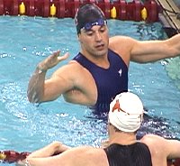 Australian Adam Pine swimming for Nebraska was the winner in the 100 Fly in a US Open Record. He congratulates second place finisher Nate Dusing on his American Record performance.
