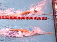 Kowal comes from behind to pass Overton on the last stroke of the 200 IM at the NCAA championships.