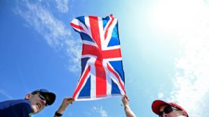 Two spectators holding the British Flag
