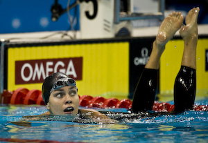Natalie Coughlin wins 100 meter backstroke.