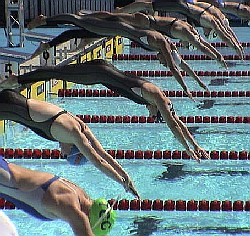 Misty Hyman, center, led qualifying in the 200 Fly