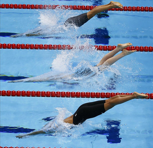 Swimmers diving into pool