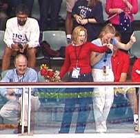 Fans of Tom Malchow cheer as he displays his gold medal.