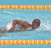 In heat 1 of the 100 Free, with three swimmers all entered at 1:10, both Lanes 3 & 4, wearing Speedo body suits, were DQd for falling in before the start.
The only remaining competitor in the heat, Eric Moussambani of Equatorial Guinea, stood alone wearing a regular suit, with his swim suit strings untied and hanging out. He dove in and sprinted the first 20 meters without a breath, then swam head-up the rest of the way to finish in 1:52.72, to the defeaning roar of the crowd. 

His splits were :40.97 - 1:11.75. 

His time would not have won the 80-84 age group at the World Masters Championships.
