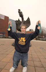 Travis Mohr holding medals