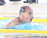 Walt Reid taking a break from the Top 10, Records, and Timing room to sneak in a 100 Breaststroke.
