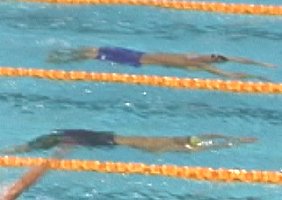 Matt Welsh is just ahead of Lenny Krayzelburg coming off the turn in the 100 Back.