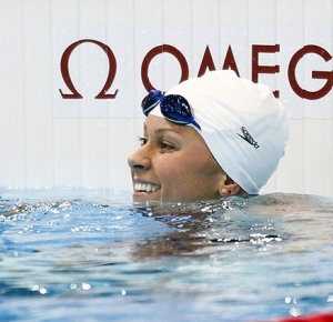Elizabeth Beisel (USA) waves to supporters in the stands after competing in a women's 400m individual medley heat during the 2012 London Olympic Games at Aquatics Centre.