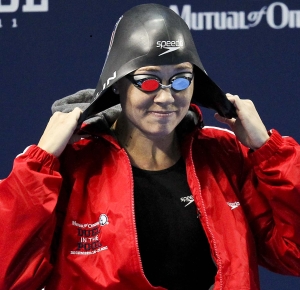 December 16, 2011; Atlanta, GA, USA; Natalie Coughlin pulls on her swim cap before the 100m butterfly at the Duel in the Pool in the Georgia Tech Aquatics Center.