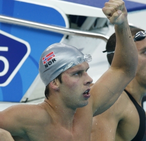 Alexander Dale Oen (NOR) celebrates after winning his semifinal heat in the 100m breaststroke at the National Aquatics Center.