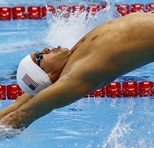 Matt Grevers (USA) dives off the starting blocks to start his men's 100m backstroke heat during the 2012 London Olympic Games at Aquatics Centre.