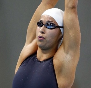 Ranomi Kromowidjojo (NED) stretches before competing in the women's 100m freestyle final during the London 2012 Olympic Games at Aquatics Centre.