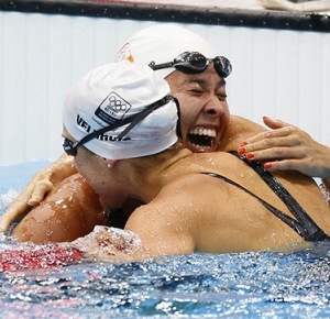 Rannomi Kromowidjojo (NED) celebrates with her teammate Marleen Veldhuis (NED) who won the bronze, after winning the gold medal in the women's 50m freestyle final during the London 2012 Olympic Games at the Aquatics Centre.