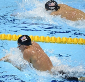 Americans Ryan Lochte (front) and teammate Michael Phelps swim the breast stroke portion of the 200m Individual Medley Semifinals during the London 2012 Olympic Games at Aquatics Centre.