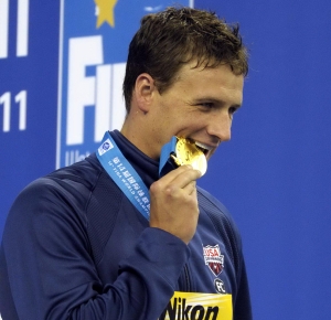 Shanghai, CHINA; Ryan Lochte (USA) poses with his gold medal after winning the men's 200m freestyle final at the 14th FINA World Championships.