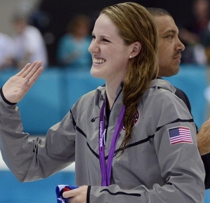 Missy Franklin (USA) waves to the crowd after winning a gold medal in the women's 100m backstroke finals during the London 2012 Olympic Games at Aquatics Centre.