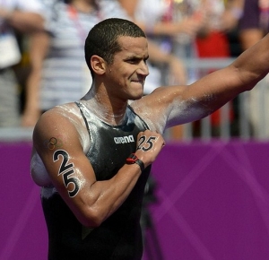 Tunisia swimmer Oussama Mellouli celebrates after winning the men's open water 10km swim during the London 2012 Olympic Games at Hyde Park.