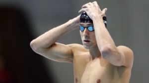 Michael Phelps (USA) adjusts his cap before competing in the men's 100m butterfly final during the London 2012 Olympic Games at Aquatics Centre.