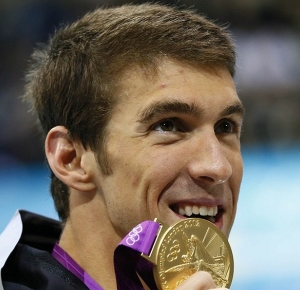 USA swimmer Michael Phelps (right) smiles after winning the gold medal in the 200m men's individual medley final during the London 2012 Olympic Games at Aquatics Centre.