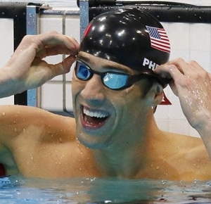 Michael Phelps (USA) removes his goggles after winning the men's 100m butterfly final during the London 2012 Olympic Games at Aquatics Centre.
