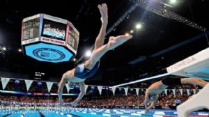 Michael Phelps jumps off the starting block prior to start the mens 200m individual medley final in the 2012 U.S. Olympic swimming team trials at the CenturyLink Center.