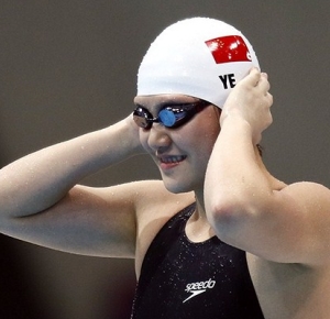 Ye Shiwen (CHN) puts on his cap in the women's 200m individual medley semifinals during the London 2012 Olympic Games at Aquatics Centre.