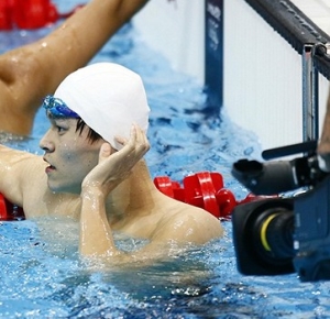 Sun Yang (CHN) and Li Yungi (CHN) react after competing during the men's 200m freestyle heats during the 2012 London Olympic Games at Aquatics Centre.