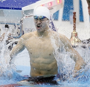 Yang Sun (CHN) celebrates after setting a new world record at 14:31.02 and winning the gold medal in the men's 1500m freestyle final during the London 2012 Olympic Games at the Aquatics Centre.