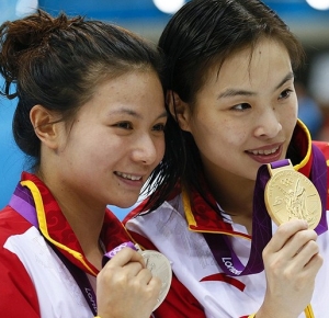 Zi He (CHN), left, and Minxia Wu show off their silver and gold medals respectively for the Women's 3m Springboard final during the London 2012 Olympic Games at Aquatics Centre.