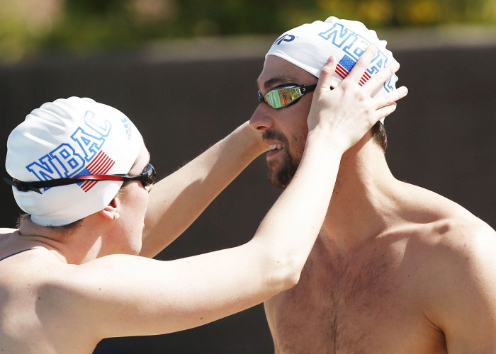 Apr 15, 2015; Mesa, AZ, USA; North Baltimore Aquatic Club teammates Allison Schmitt and Michael Phelps check their goggles during practice session at the Arena Pro Swim Series at Skyline Aquatic Center. Mandatory Credit: Rob Schumacher/Arizona Republic via USA TODAY Sports