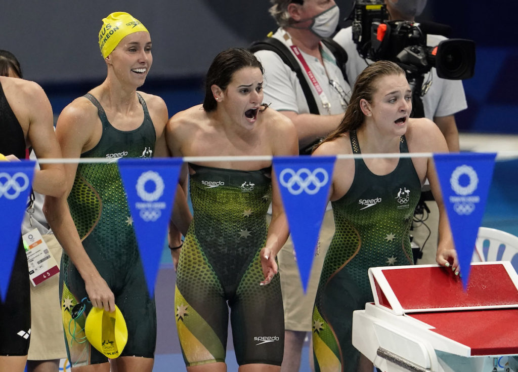 Aug 1, 2021; Tokyo, Japan; Kaylee McKeown (AUS), Chelsea Hodges (AUS) and Emma McKeon (AUS) celebrate their victory in the women's 4x100m medley final during the Tokyo 2020 Olympic Summer Games at Tokyo Aquatics Centre. Mandatory Credit: Rob Schumacher-USA TODAY Sports - Australia